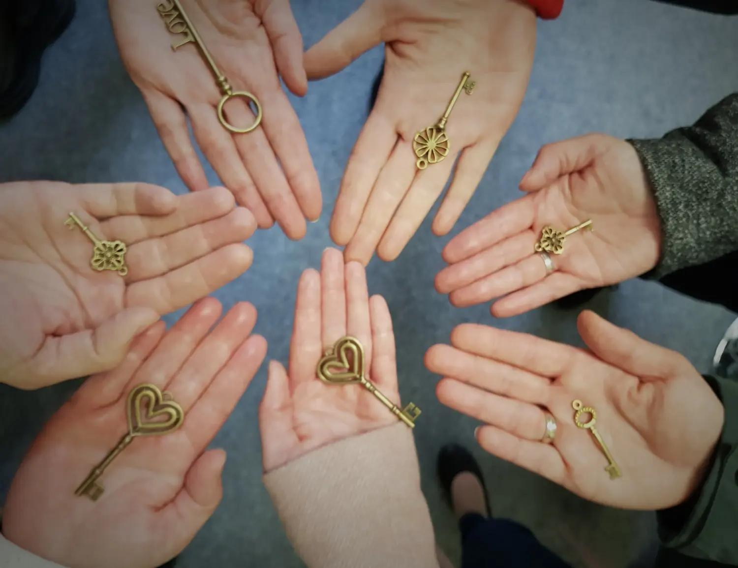 Hand hält einen dekorativen Schlüssel im Retro-Stil in goldener Farbe von ganzheitliches Schmerzcoaching